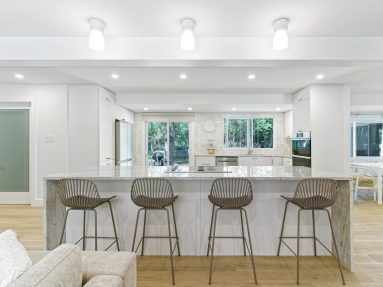 High-end bright and airy kitchen interior with waterfall island and hardwood floors in Ottawa captured by Brandplayers.